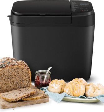 Panificadora Panasonic SD-R2530KXE en cocina con hogaza y panecillos